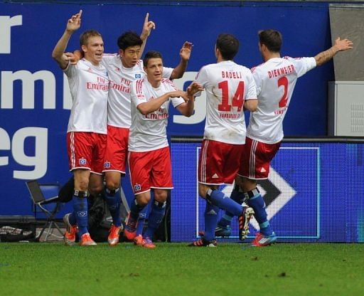Hamburg's players celebrate the goal scored by striker Artjoms Rudnevs (L)